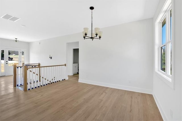 81 Bridgemill Dr, Douglasville, GA 30134 - empty room featuring light wood finished floors and a chandelier