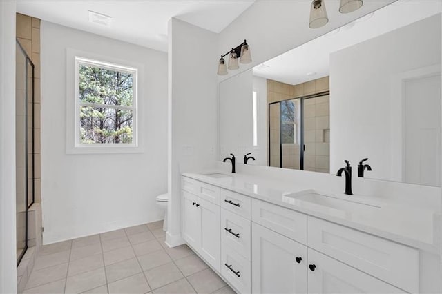 81 Bridgemill Dr, Douglasville, GA 30134 - bathroom with a shower stall, double vanity, and tile patterned floors