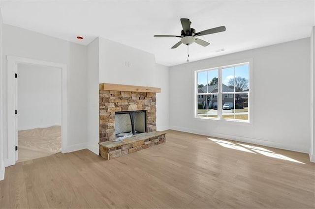 81 Bridgemill Dr, Douglasville, GA 30134 - unfurnished living room with wood finished floors, a stone fireplace, and ceiling fan