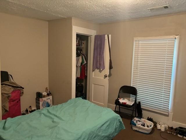 bedroom featuring a closet and a textured ceiling