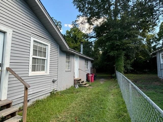 view of side of home featuring a lawn