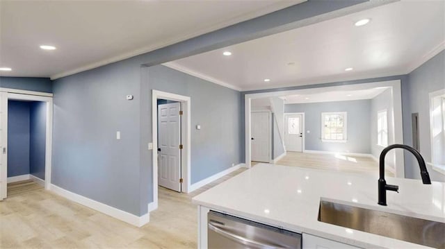 kitchen featuring sink, light wood-type flooring, dishwasher, light stone counters, and crown molding