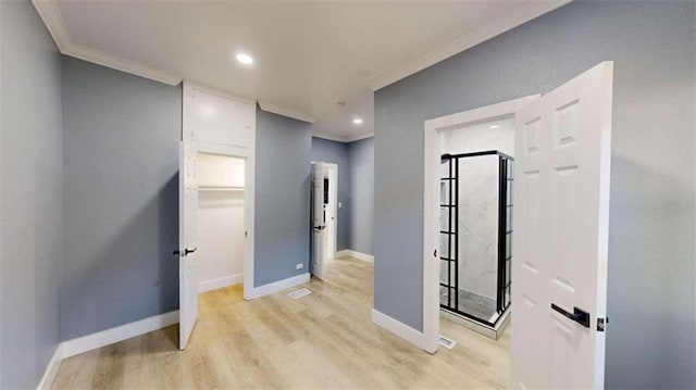 corridor with ornamental molding and light wood-type flooring