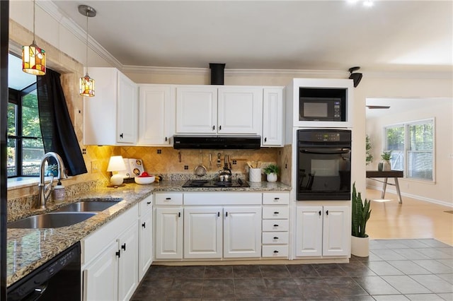 kitchen featuring black appliances, sink, backsplash, hanging light fixtures, and white cabinetry