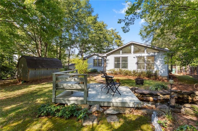 exterior space with a yard, a storage shed, and a wooden deck