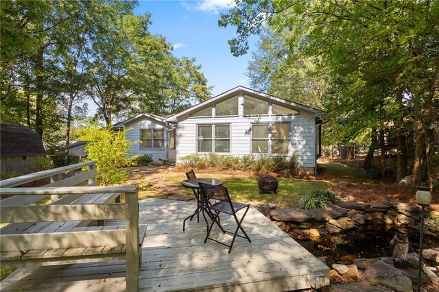 back of property with a wooden deck