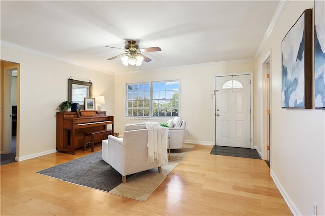 living room with ornamental molding, light wood-type flooring, and ceiling fan