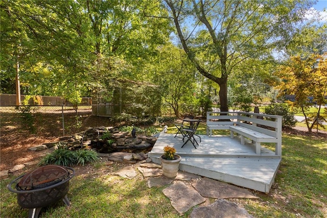 view of yard featuring a wooden deck and an outdoor fire pit