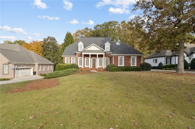 cape cod-style house with a garage, covered porch, and a front lawn