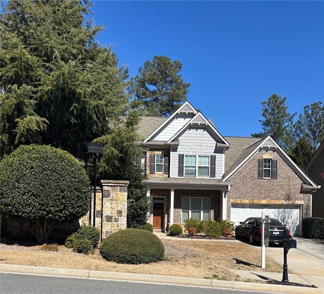 craftsman-style home with driveway and brick siding