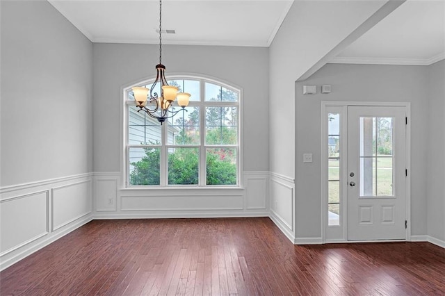 entryway featuring dark wood-style floors, a wealth of natural light, and ornamental molding