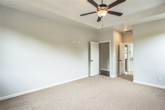 unfurnished bedroom with carpet, baseboards, visible vents, and a ceiling fan