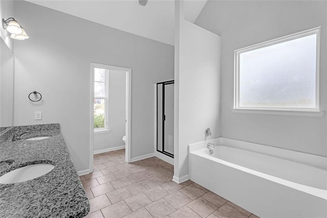 bathroom featuring tile patterned flooring, a garden tub, a sink, and a shower stall