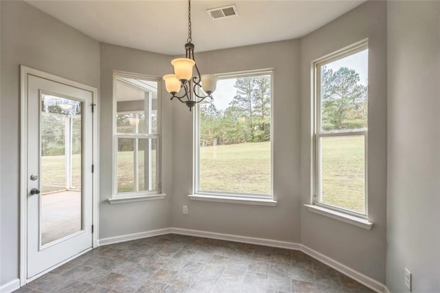 unfurnished dining area with a notable chandelier, visible vents, and baseboards