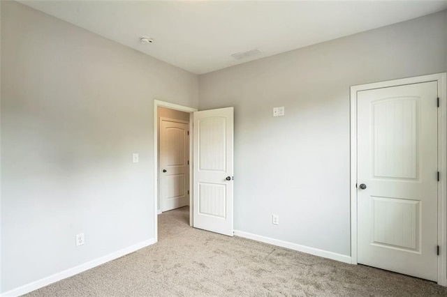 unfurnished bedroom with baseboards and carpet flooring