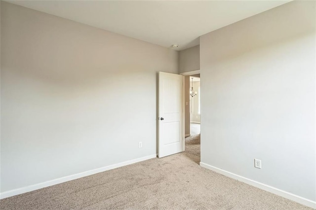 spare room with carpet flooring and baseboards