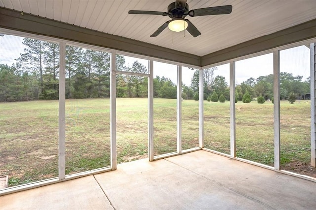 unfurnished sunroom with ceiling fan