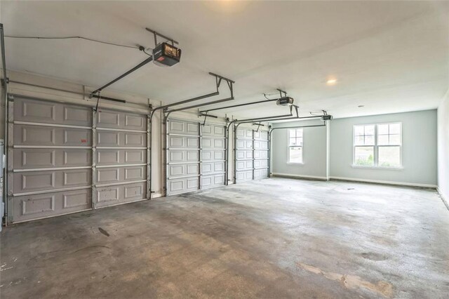 garage featuring a garage door opener and baseboards