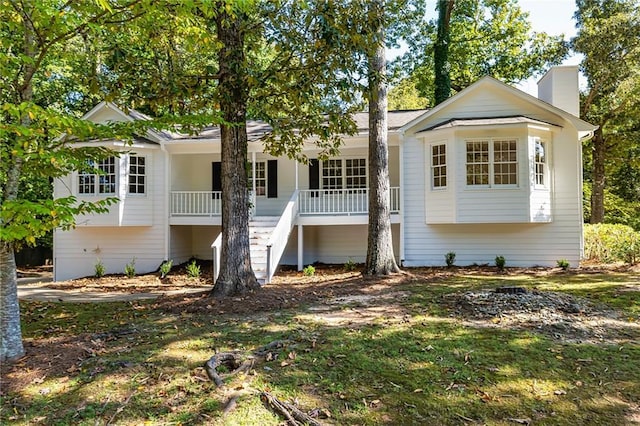 rear view of house featuring covered porch