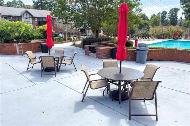 6851 Roswell Rd Unit J1, Atlanta, GA 30328 - view of patio with outdoor dining area and a community pool