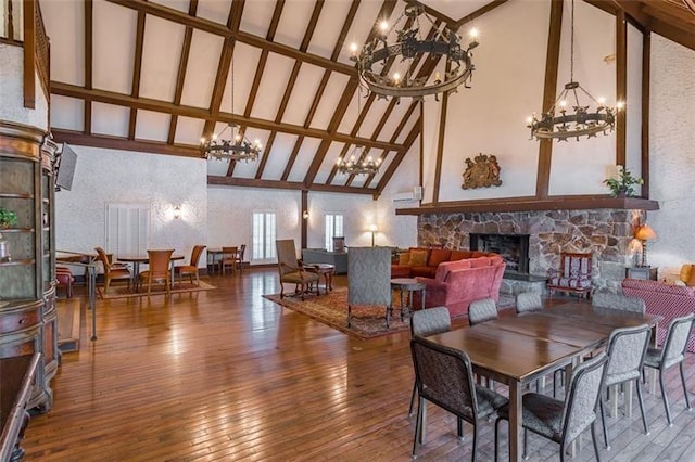 6851 Roswell Rd Unit J1, Atlanta, GA 30328 - dining area with a chandelier, high vaulted ceiling, a stone fireplace, hardwood / wood-style floors, and beam ceiling