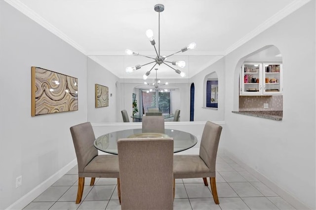 6851 Roswell Rd Unit J1, Atlanta, GA 30328 - dining space featuring ornamental molding, a chandelier, baseboards, tile patterned flooring, and arched walkways