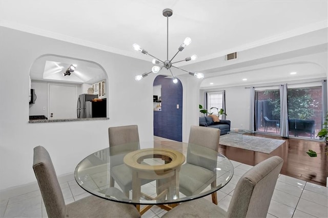 6851 Roswell Rd Unit J1, Atlanta, GA 30328 - dining area with arched walkways, a chandelier, baseboards, tile patterned flooring, and ornamental molding