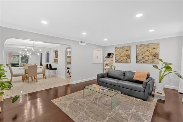 6851 Roswell Rd Unit J1, Atlanta, GA 30328 - living room with arched walkways, a chandelier, wood finished floors, baseboards, and recessed lighting