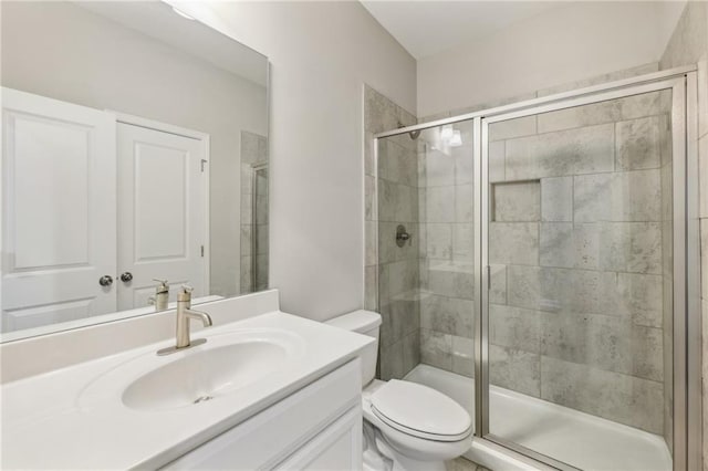 bathroom featuring walk in shower, vanity, and toilet