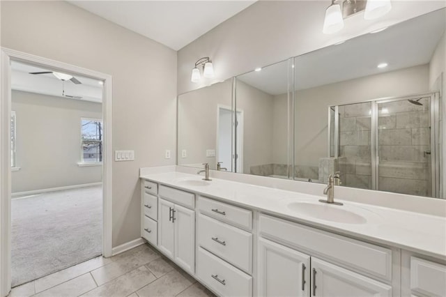 bathroom featuring vanity, tile patterned flooring, and a shower with shower door