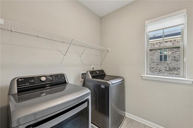 washroom with washer and dryer