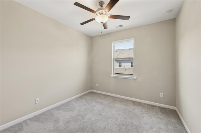 spare room featuring light carpet and ceiling fan