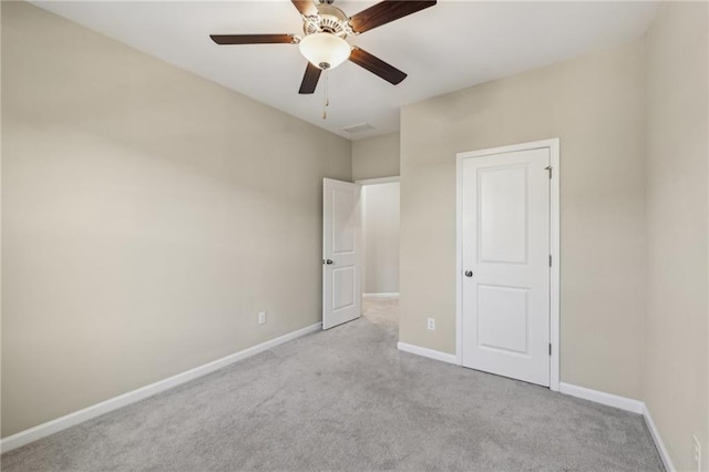 unfurnished bedroom featuring ceiling fan and light carpet