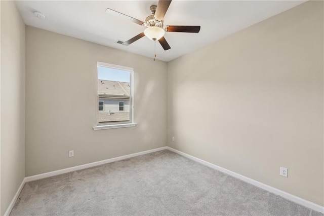 spare room with light carpet and ceiling fan