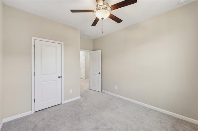 unfurnished bedroom featuring light carpet and ceiling fan