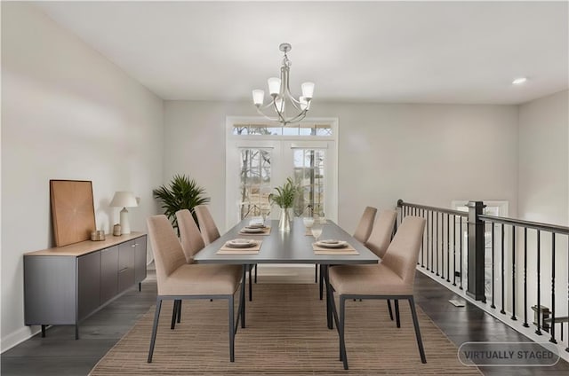 dining area with dark hardwood / wood-style flooring and a chandelier