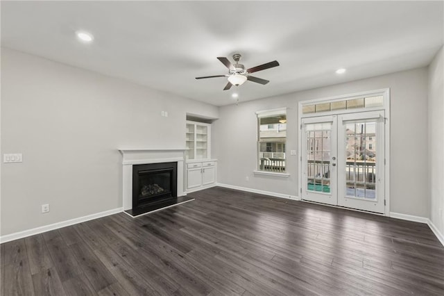 unfurnished living room with french doors, ceiling fan, dark hardwood / wood-style floors, and built in features