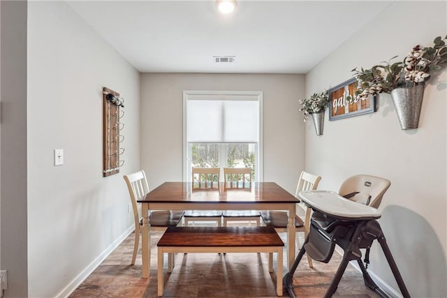 dining space featuring hardwood / wood-style flooring