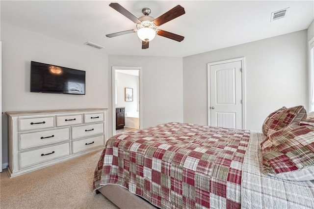 carpeted bedroom with connected bathroom and ceiling fan