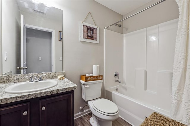 full bathroom featuring hardwood / wood-style flooring, shower / tub combo with curtain, vanity, and toilet