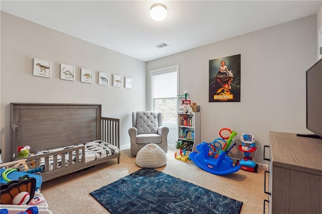 carpeted bedroom featuring a crib