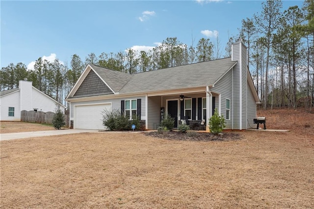 ranch-style house featuring a garage, covered porch, and a front lawn