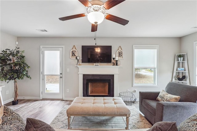 living room with ceiling fan and light hardwood / wood-style floors