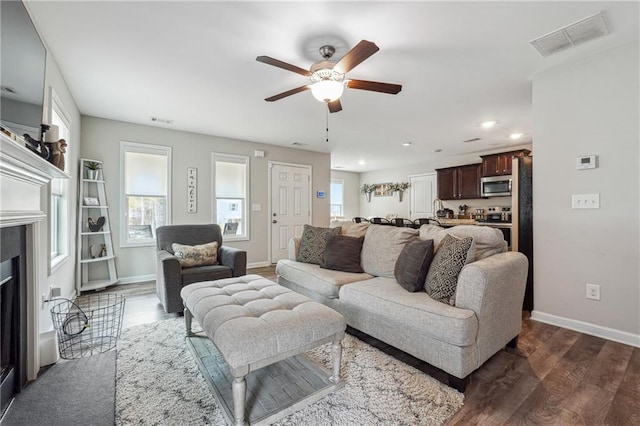 living room featuring dark hardwood / wood-style floors and ceiling fan