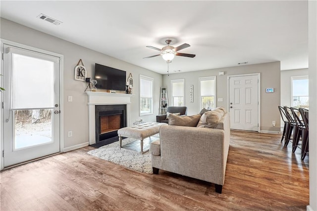 living room featuring hardwood / wood-style flooring and ceiling fan