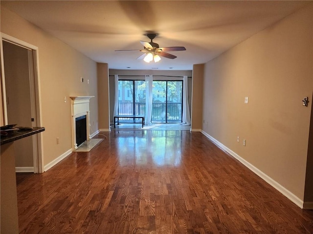 2303 Pine Heights Dr NE, Atlanta, GA 30324 - unfurnished living room featuring a ceiling fan, dark wood-style floors, and a fireplace with flush hearth