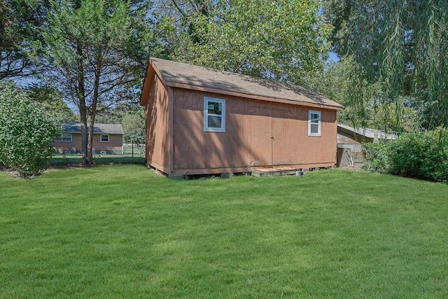 view of outbuilding featuring a lawn