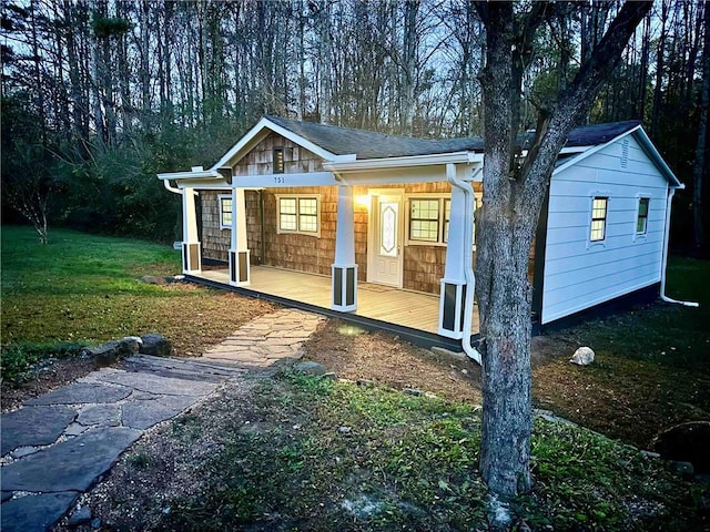 exterior space featuring a front yard and covered porch