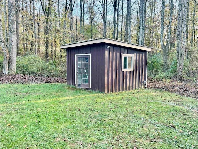 view of outbuilding featuring a yard