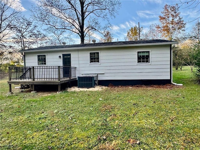 rear view of property with a lawn, central AC, and a deck